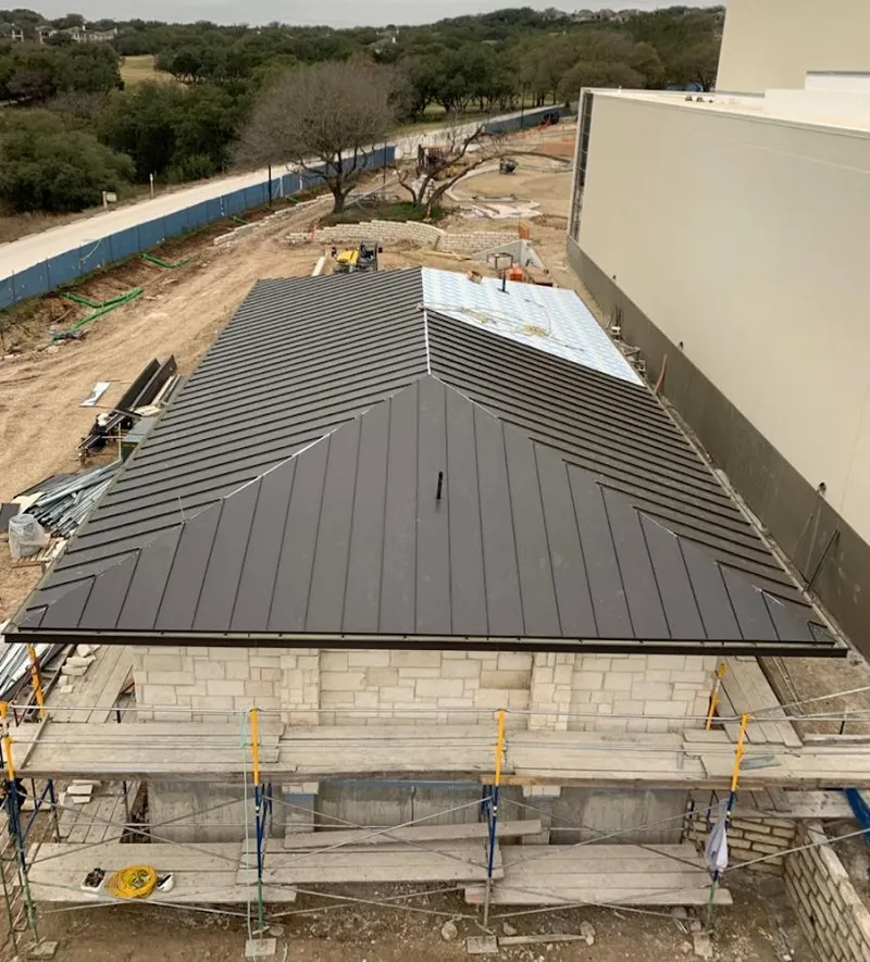 Metal roof new construction with scaffolding in Hebron